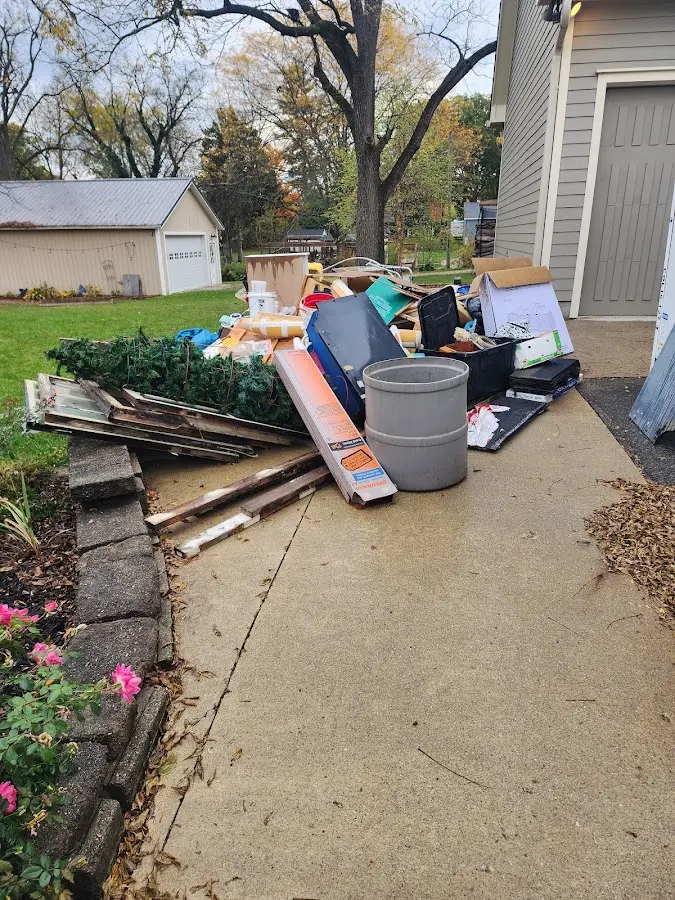 Dumpster being loaded with debris for Demolition Dumpster Rental in Joplin